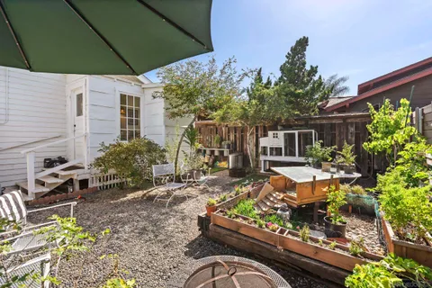 a view of a house with backyard porch and sitting area