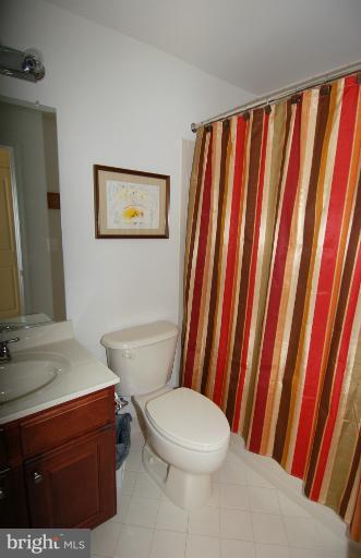 1309 Rome Court Odenton, MD 21113 - Photo 12 of 30 a white toilet sitting next to a bathroom sink