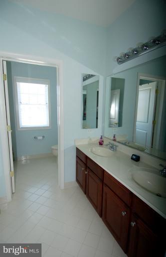 1309 Rome Court Odenton, MD 21113 - Photo 20 of 30 a bathroom with a double vanity sink and a mirror
