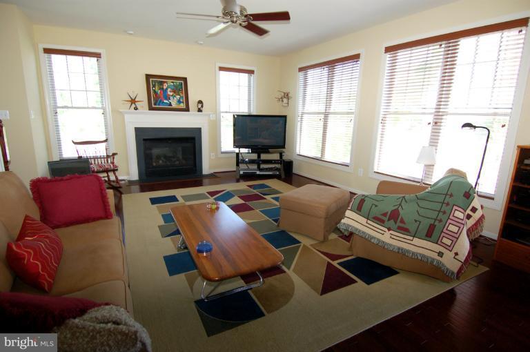 1309 Rome Court Odenton, MD 21113 - Photo 23 of 30 a living room with furniture a fireplace and a flat screen tv