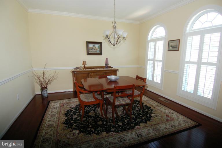 1309 Rome Court Odenton, MD 21113 - Photo 24 of 30 a dining room with wooden floor and a window