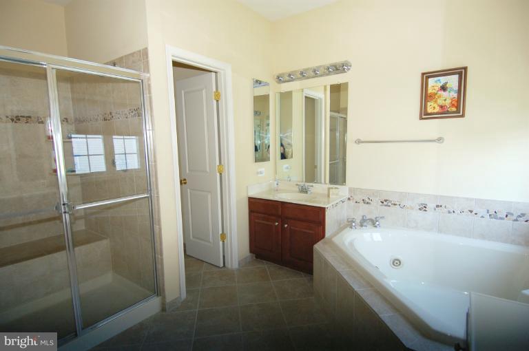 1309 Rome Court Odenton, MD 21113 - Photo 26 of 30 a bathroom with a tub sink and mirror