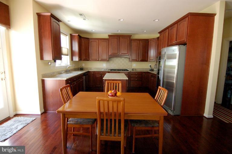 1309 Rome Court Odenton, MD 21113 - Photo 7 of 30 a view of a dining room with furniture window and wooden floor