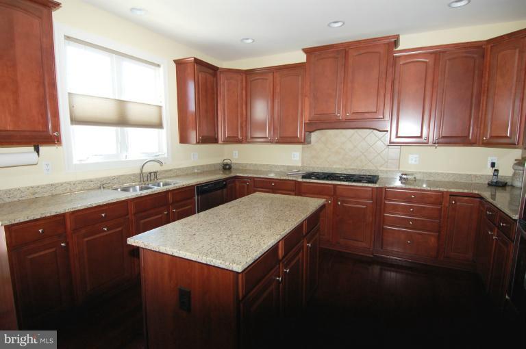 1309 Rome Court Odenton, MD 21113 - Photo 8 of 30 a kitchen with a sink a cabinets and window