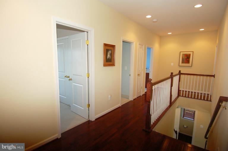 1309 Rome Court Odenton, MD 21113 - Photo 9 of 30 a view of a hallway with wooden floor and staircase