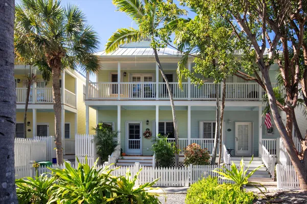 front view of a house with potted plants
