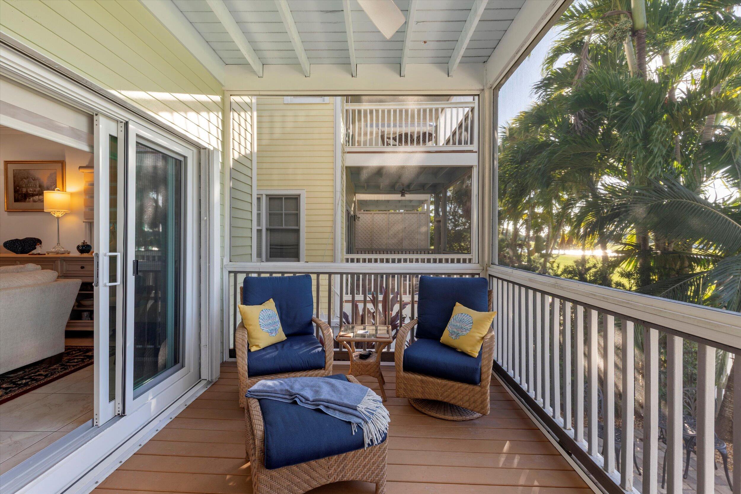 44 Spoonbill Way, Unit 1 Key West, FL 33040 - Photo 13 of 83 a view of a porch with furniture and a yard