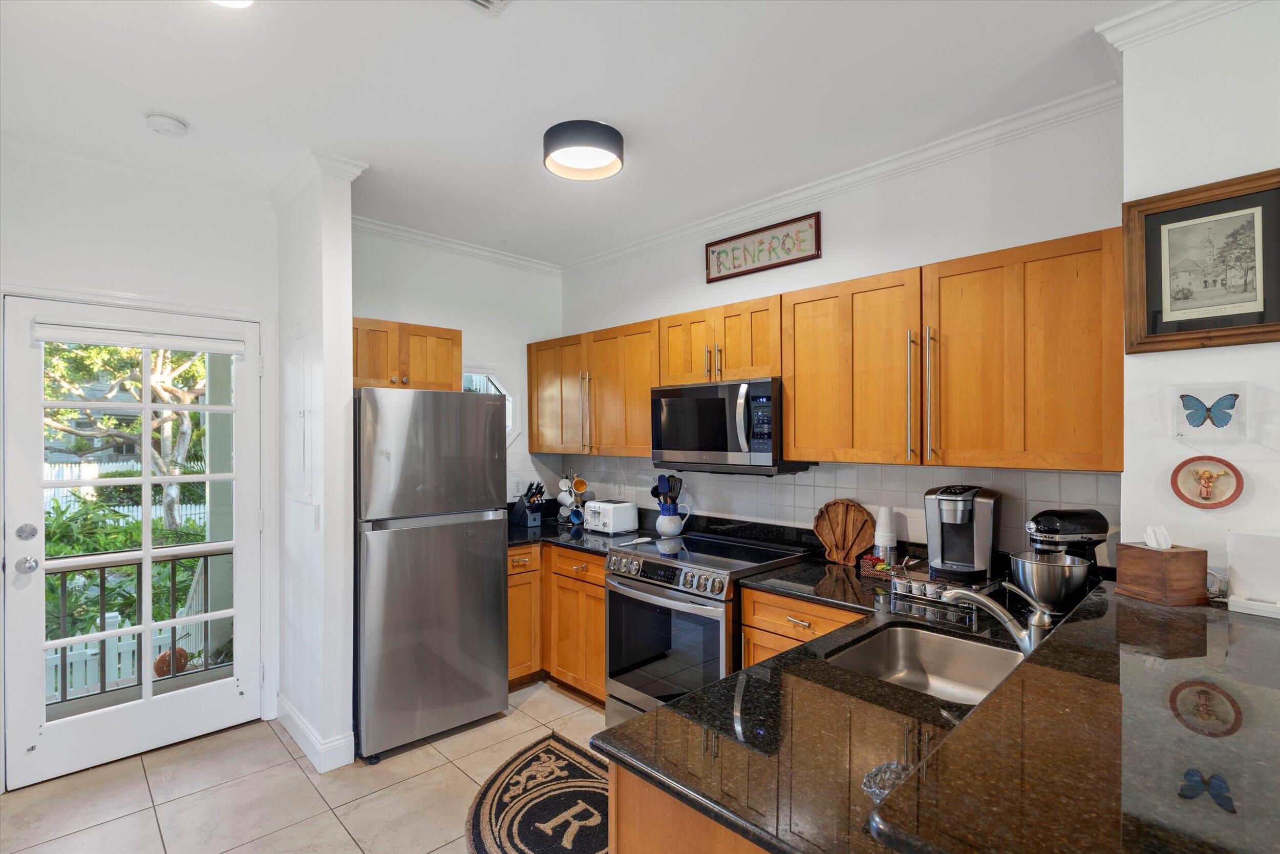 44 Spoonbill Way, Unit 1 Key West, FL 33040 - Photo 17 of 83 a kitchen with a refrigerator a stove a sink and a microwave
