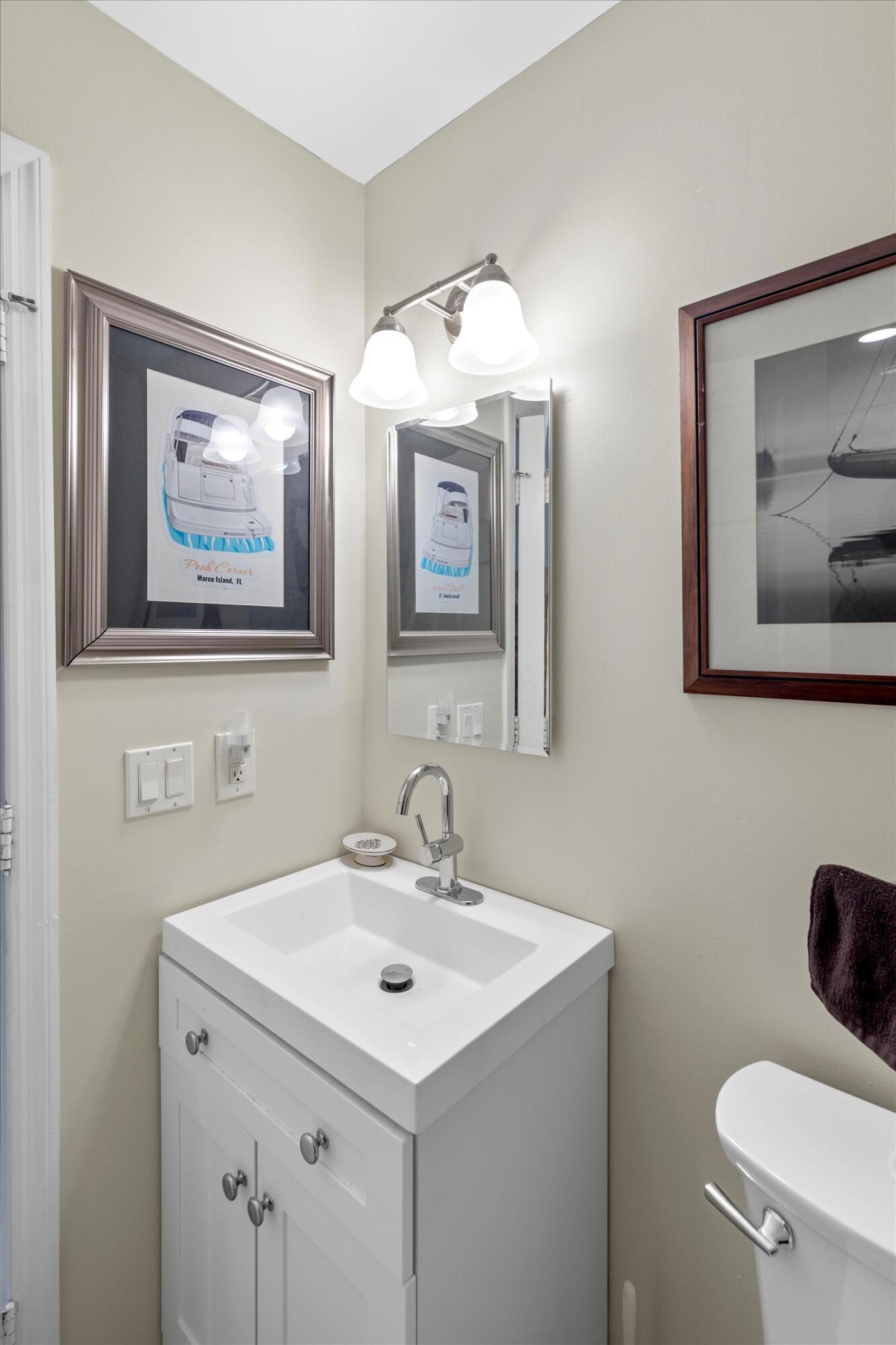 44 Spoonbill Way, Unit 1 Key West, FL 33040 - Photo 21 of 83 a bathroom with a sink and a mirror