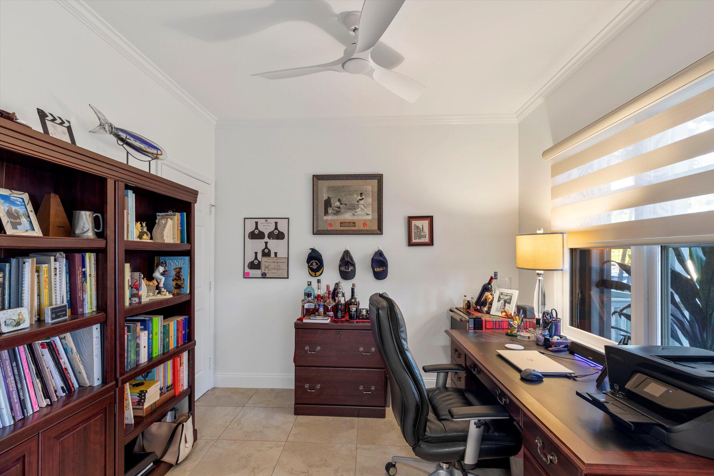 44 Spoonbill Way, Unit 1 Key West, FL 33040 - Photo 23 of 83 a view of a workspace with furniture and a bookshelf