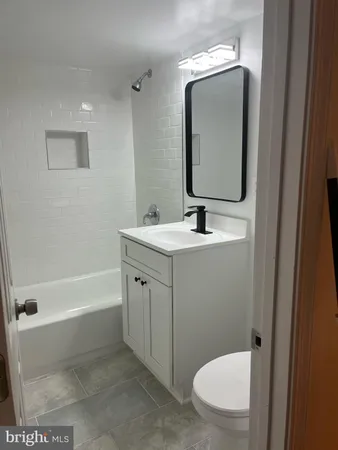 a bathroom with a sink a toilet and bathtub
