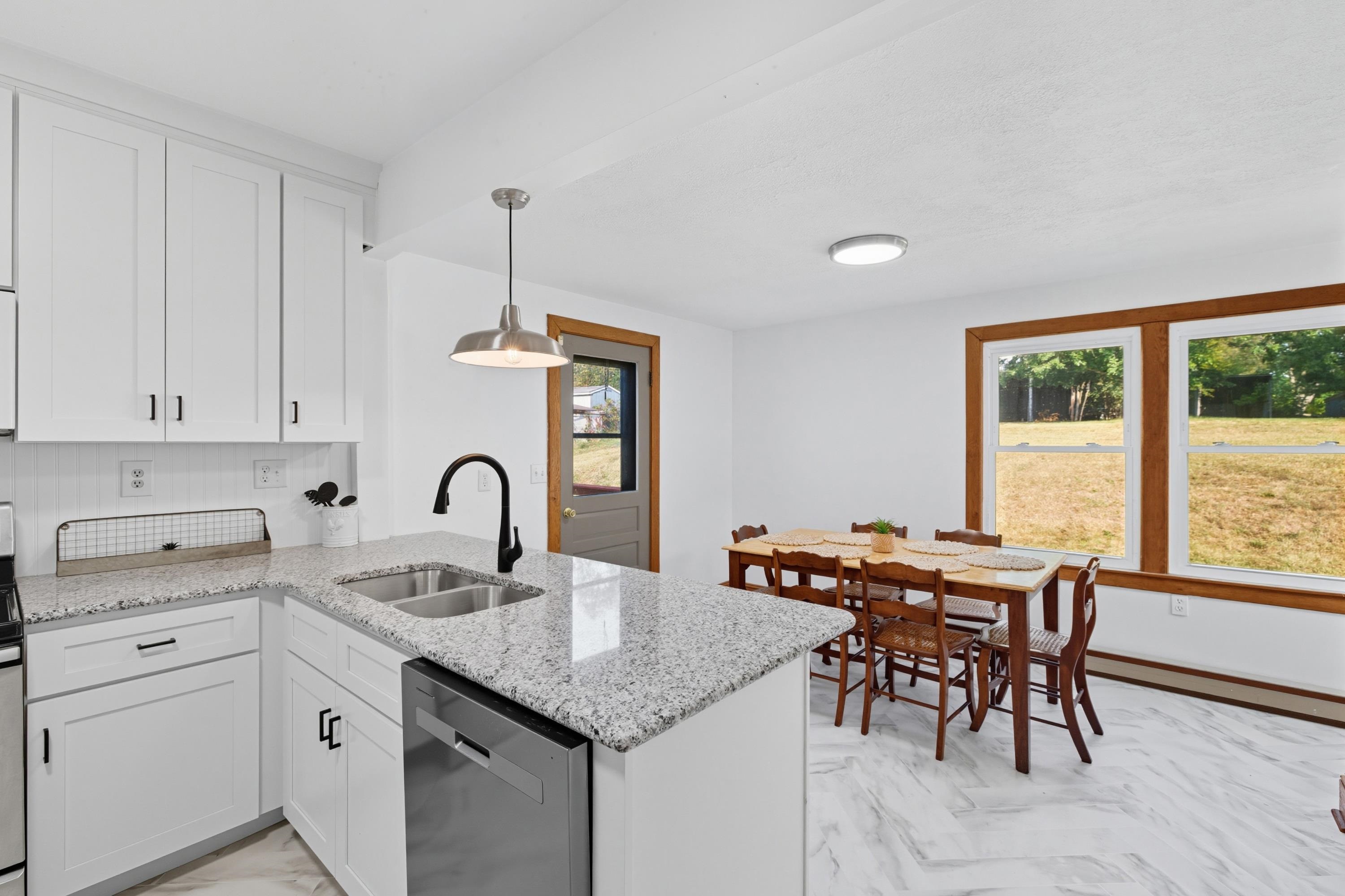 3138 Cross Keys Road Harrisonburg, VA 22801 - Photo 5 of 74 The large kitchen in the home features white wooden cabinets, granite counter-tops, eat-up breakfast bar area, and luxury vinyl tile throughout. This kitchen also features stainless steel appliances.