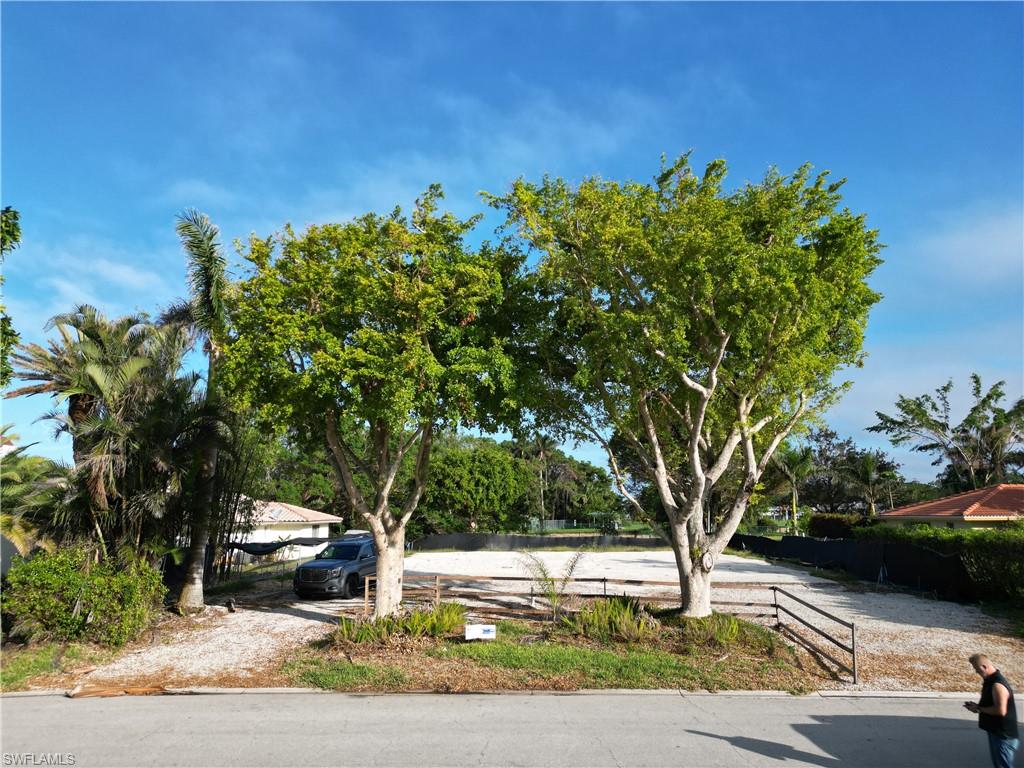 565 Whispering Pine Lane Naples, FL 34103 - Photo 4 of 12 a view of a yard with plants and trees
