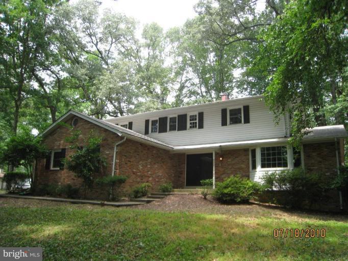 7404 Braddock Road Annandale, VA 22003 - Photo 1 of 15 a front view of a house with a yard and garage
