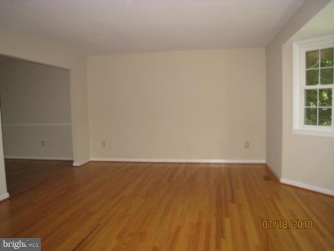 7404 Braddock Road Annandale, VA 22003 - Photo 2 of 15 an empty room with wooden floor and windows