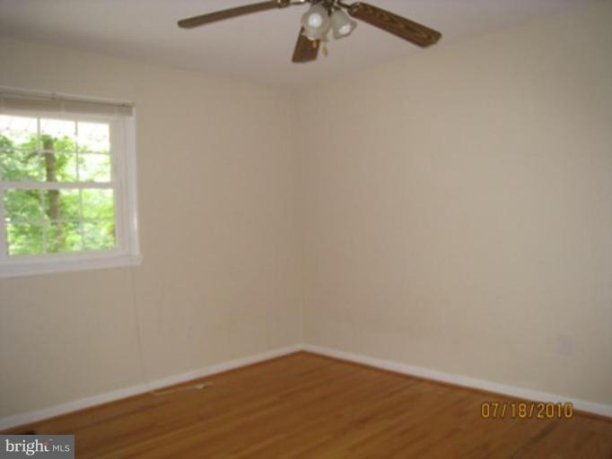 7404 Braddock Road Annandale, VA 22003 - Photo 11 of 15 a view of a small space with wooden floor and a window