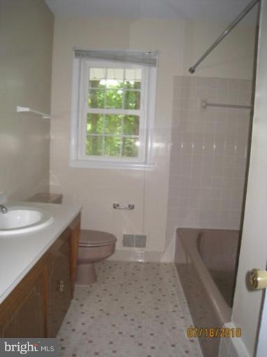 7404 Braddock Road Annandale, VA 22003 - Photo 13 of 15 a bathroom with a sink a toilet and tub