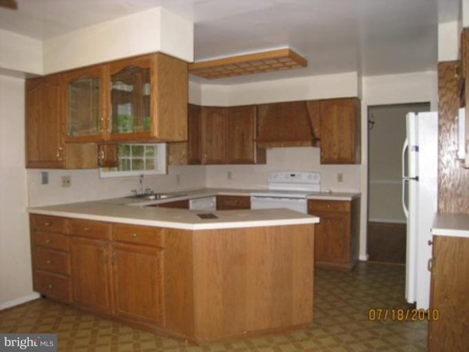 7404 Braddock Road Annandale, VA 22003 - Photo 4 of 15 a kitchen with stainless steel appliances granite countertop a sink a stove and refrigerator