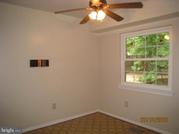 7404 Braddock Road Annandale, VA 22003 - Photo 6 of 15 an empty room with a window and a fan