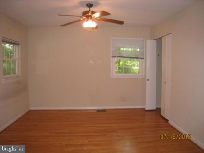 7404 Braddock Road Annandale, VA 22003 - Photo 7 of 15 an empty room with windows and fan