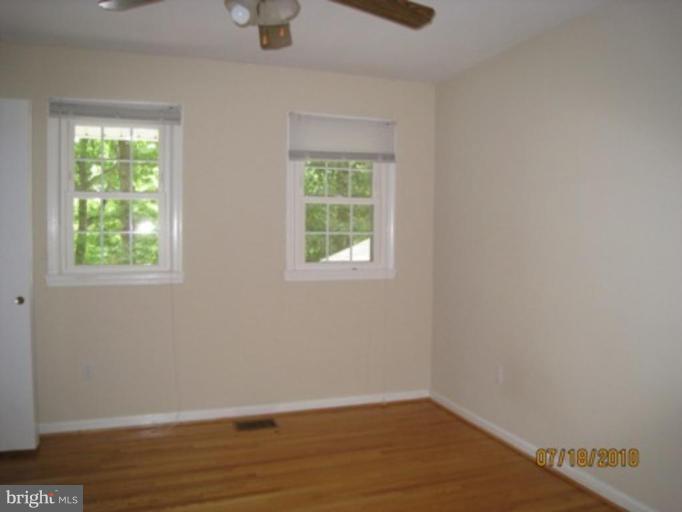 7404 Braddock Road Annandale, VA 22003 - Photo 9 of 15 an empty room with wooden floor and windows