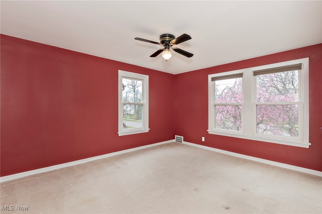 3826 Silsby Road Cleveland, OH 44118 - Photo 24 of 41 Carpeted spare room with baseboards, ceiling fan, and a healthy amount of sunlight