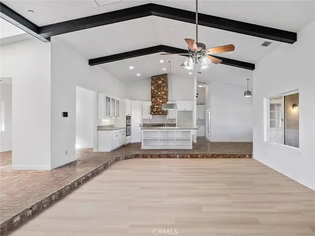 a kitchen with white cabinets and chandelier