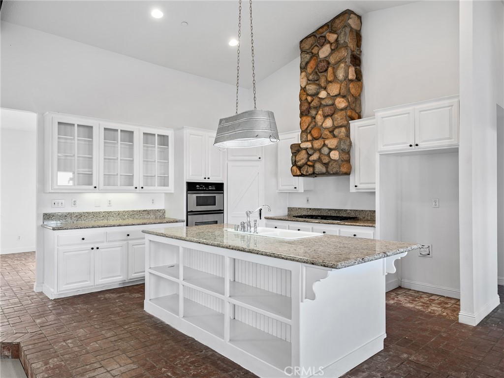 8135 Winmar Road Hesperia, CA 92344 - Photo 15 of 52 a kitchen with white cabinets and chandelier