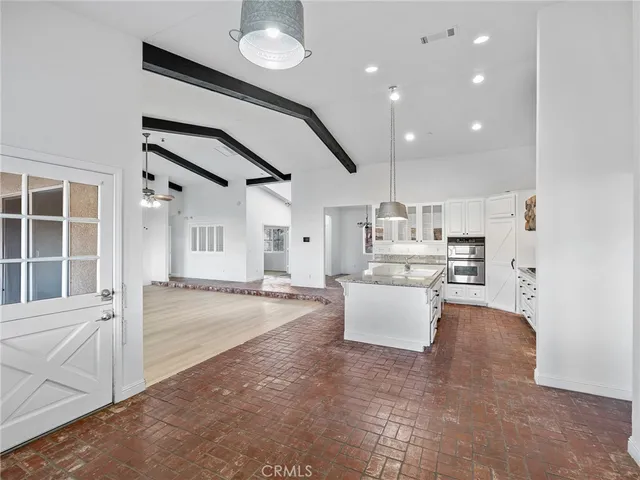 a view of an empty room window and wooden floor