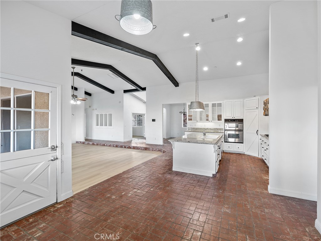 8135 Winmar Road Hesperia, CA 92344 - Photo 19 of 52 a view of kitchen and living room with wooden floor