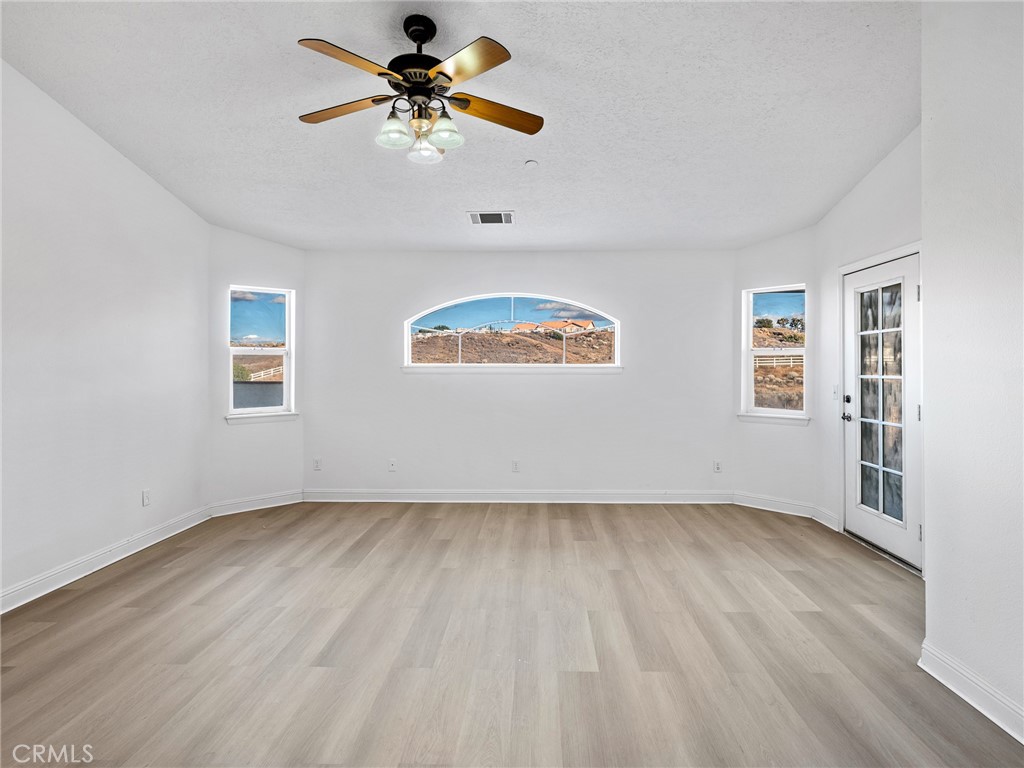 8135 Winmar Road Hesperia, CA 92344 - Photo 20 of 52 a view of an empty room window and wooden floor