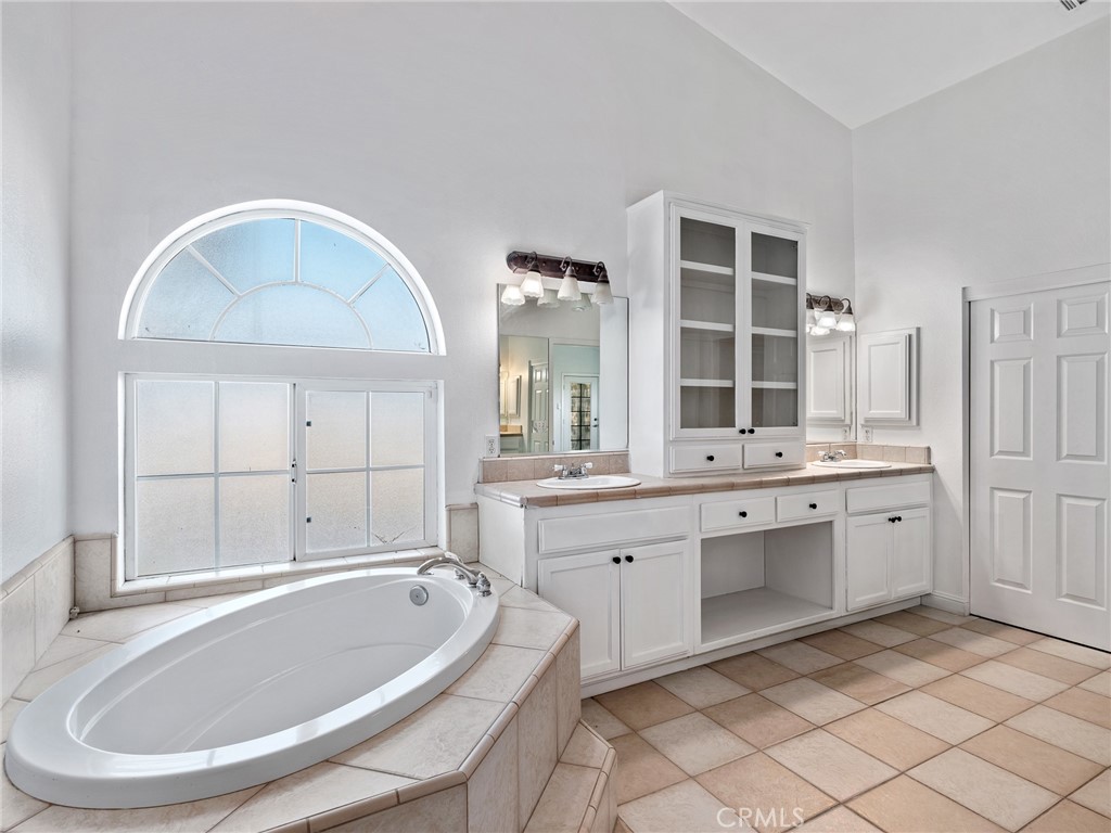 8135 Winmar Road Hesperia, CA 92344 - Photo 25 of 52 a bathroom with a tub sink and mirror