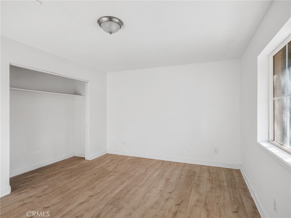 8135 Winmar Road Hesperia, CA 92344 - Photo 32 of 52 a view of empty room with wooden floor and fan