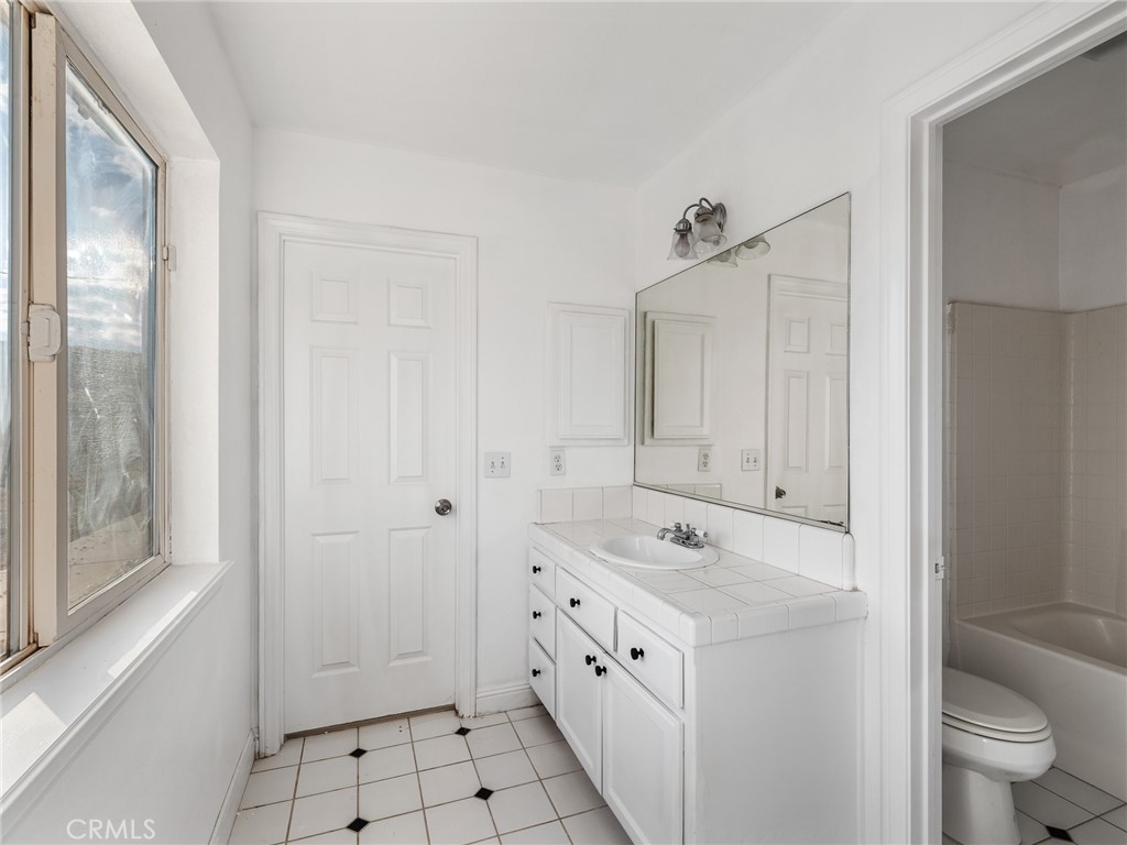 8135 Winmar Road Hesperia, CA 92344 - Photo 36 of 52 a spacious bathroom with a double vanity sink a toilet and a shower
