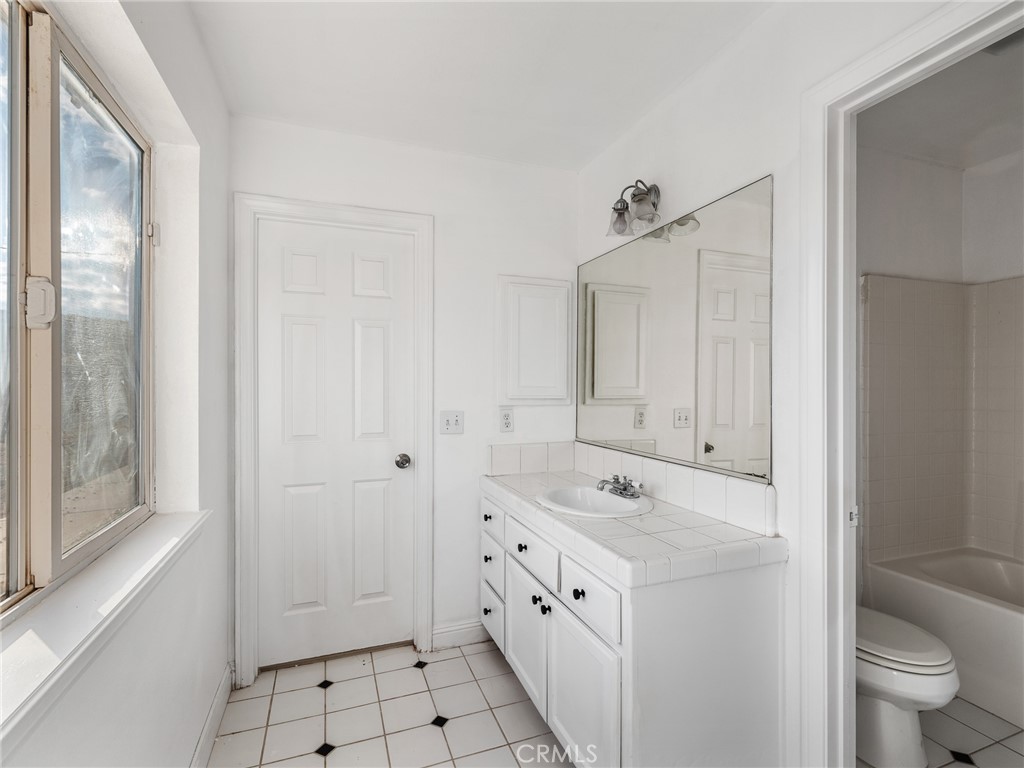 8135 Winmar Road Hesperia, CA 92344 - Photo 36 of 52 a spacious bathroom with a double vanity sink a toilet and a shower