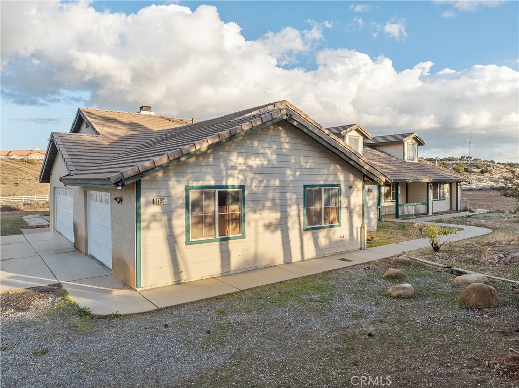 8135 Winmar Road Hesperia, CA 92344 - Photo 47 of 52 a front view of a house with a garden