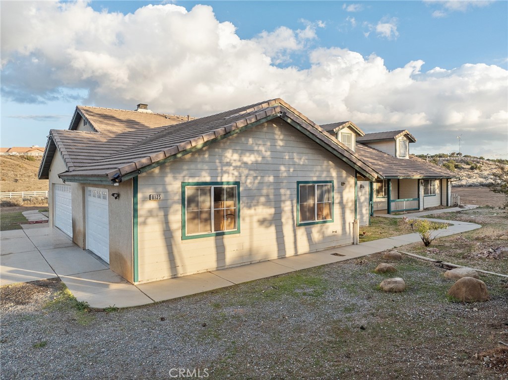 8135 Winmar Road Hesperia, CA 92344 - Photo 47 of 52 a front view of a house with a garden