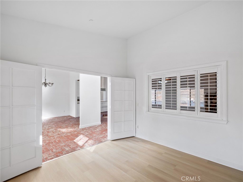 8135 Winmar Road Hesperia, CA 92344 - Photo 10 of 52 a view of an empty room with wooden floor and windows