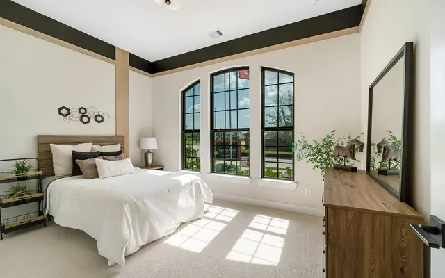 a bedroom with a large bed and a large window