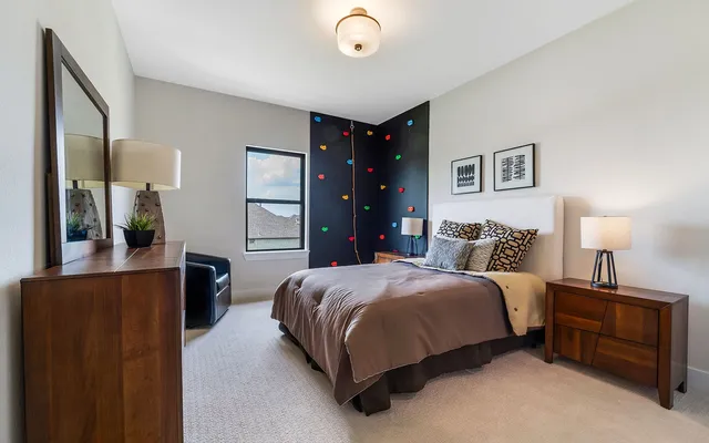 a bedroom with a bed and a dresser