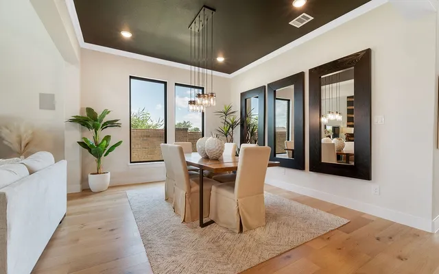 a dining room with furniture a chandelier and window