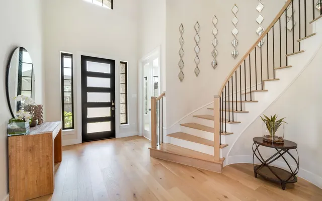 a view of a livingroom with wooden floor and furniture