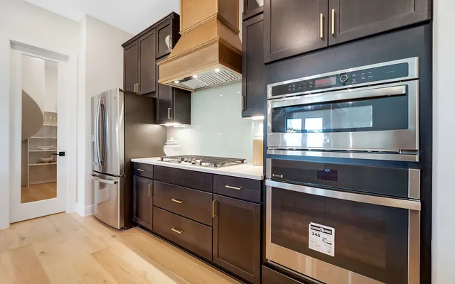 a kitchen with stainless steel appliances granite countertop a stove and a refrigerator