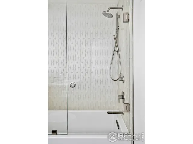 a bathroom with a shower and a sink