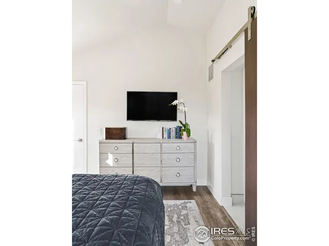 a room with a dresser and a flat screen tv