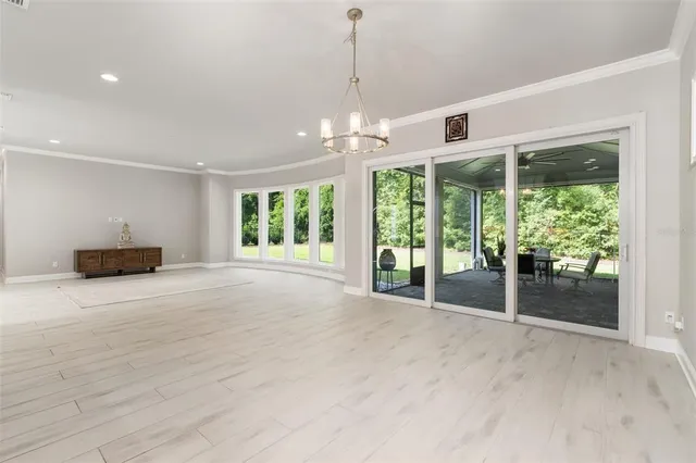 a large kitchen with stainless steel appliances kitchen island granite countertop a large cabinets a sink and a counter top space