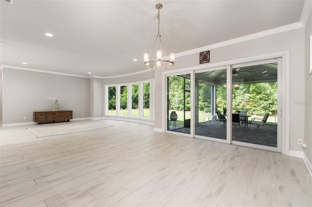 3474 Southwest 109 Drive Gainesville, FL 32608 - Photo 11 of 60 a view of an empty room with a window and chandelier