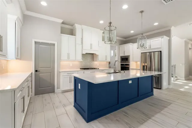 a kitchen with granite countertop a sink stainless steel appliances and cabinets