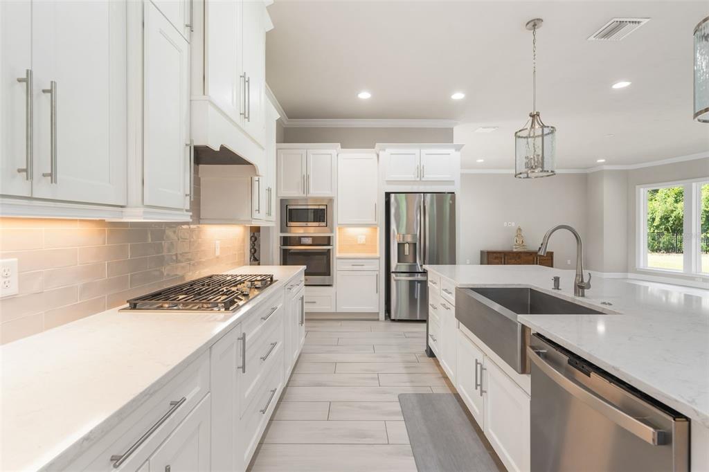 3474 Southwest 109 Drive Gainesville, FL 32608 - Photo 18 of 60 a kitchen with stainless steel appliances granite countertop a sink stove and refrigerator