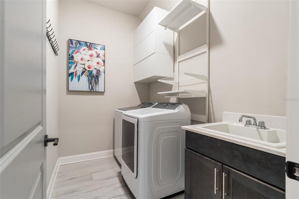 3474 Southwest 109 Drive Gainesville, FL 32608 - Photo 20 of 60 a bathroom with a sink and a washer dryer